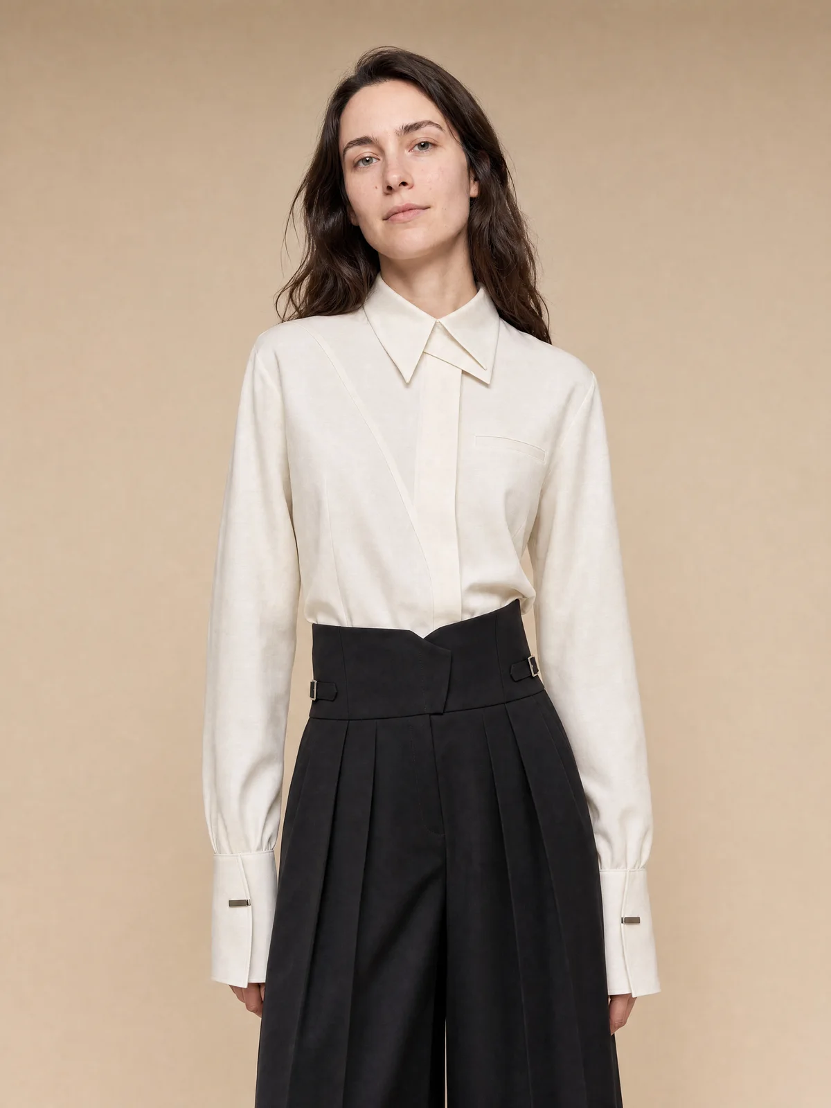 Close-up on-model studio image of the texture and collar of a cream shirt