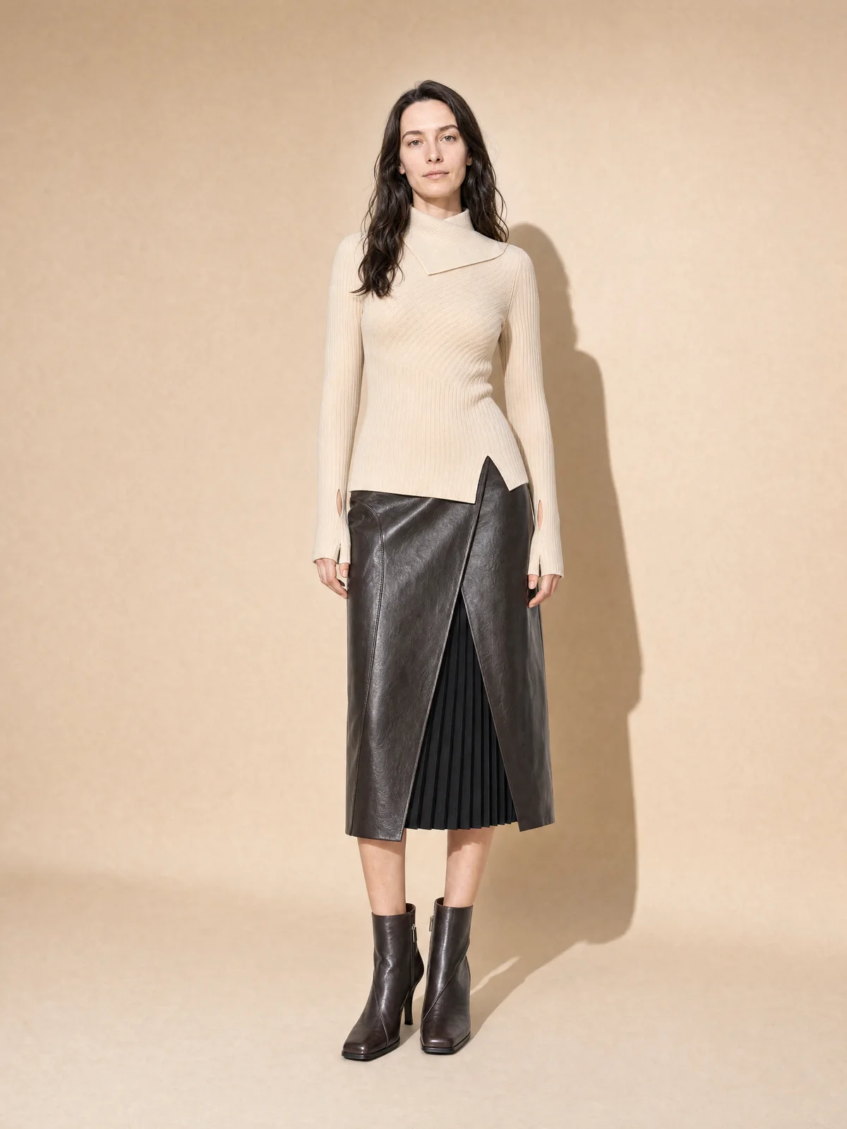 Close-up on-model image highlighting the ribbed texture of a cream knit