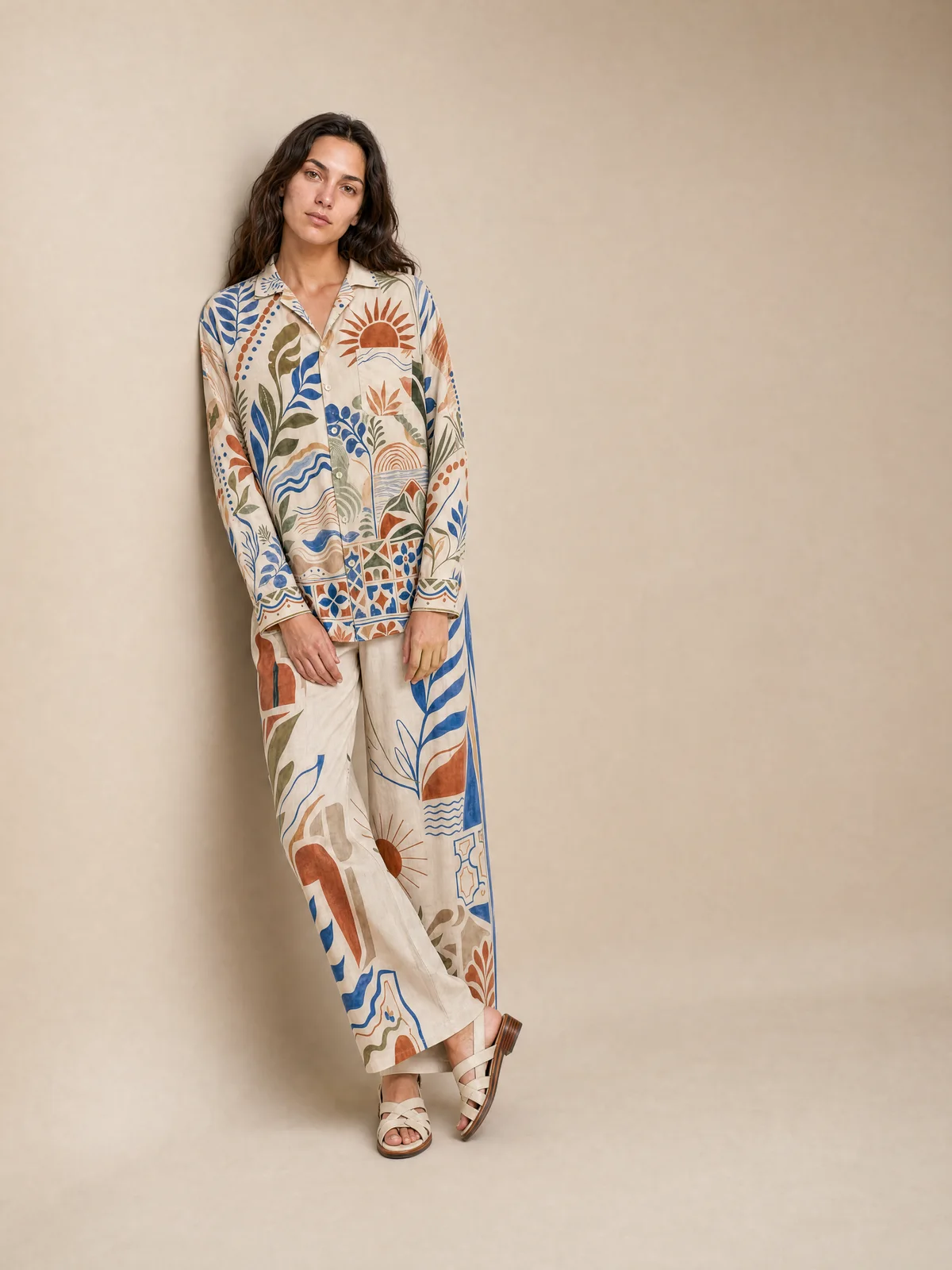 Seated on-model image of a printed co-ord in a warm editorial setting