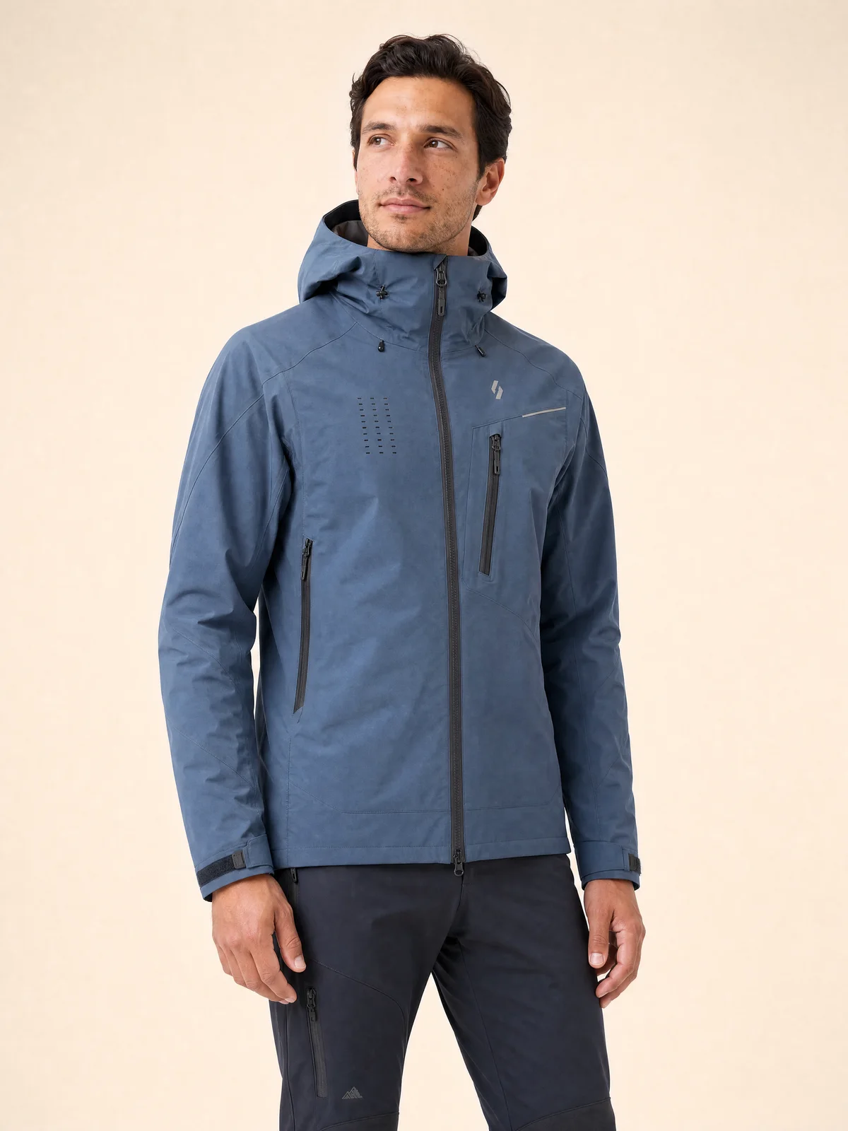 Three-quarter on-model detail of a technical jacket with hood and hardware